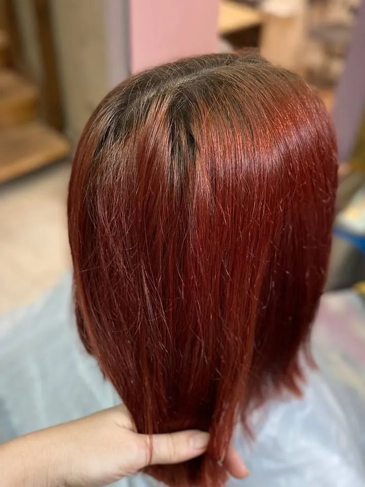 The same bob before coloring: red with dark roots