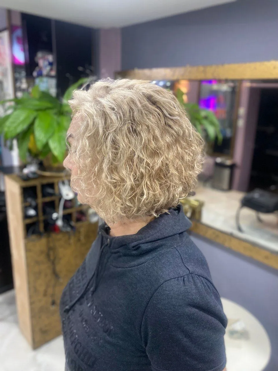 Light curly hair in a calm shade, seen from the side